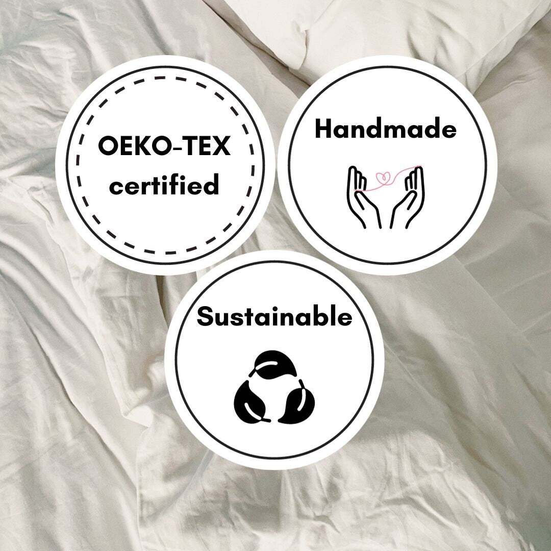 Three circular stickers on a textured fabric background, featuring 'OEKO-TEX certified', 'Handmade', and 'Sustainable' text.
