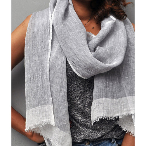 Amalfi gauze scarf in ight gray with white edges on model with a neutral background