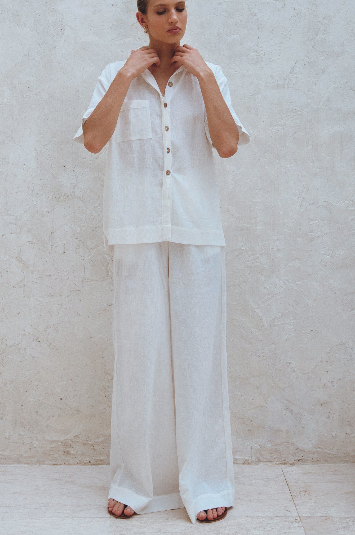 Classic linen pants in white on model.